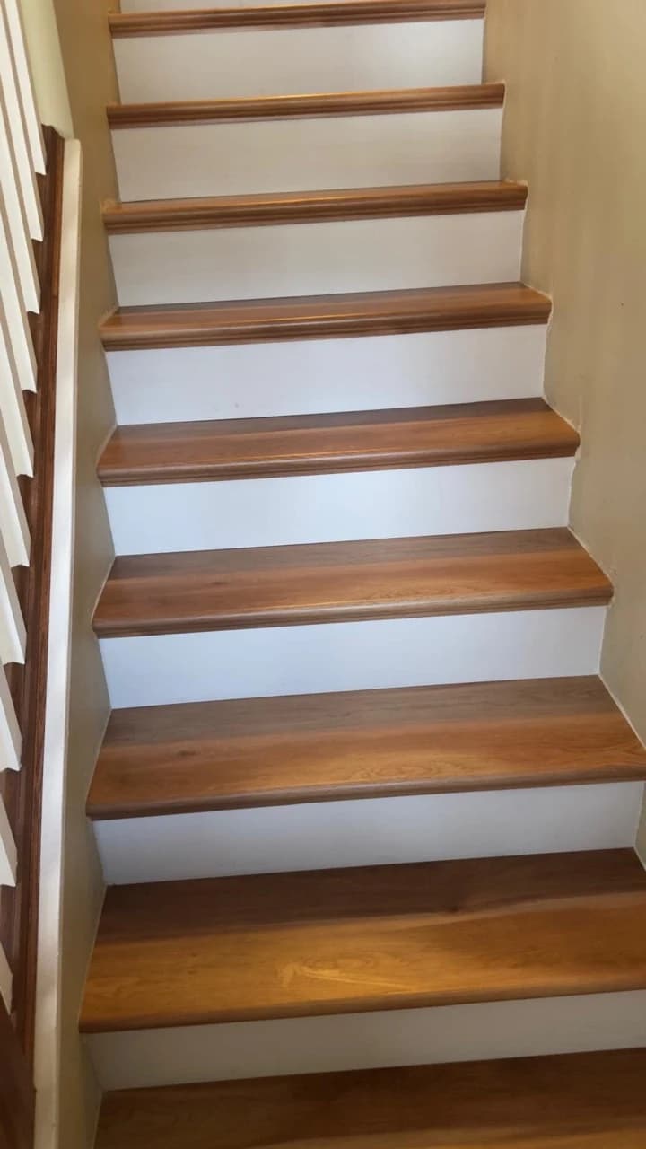 Warm wood-toned stair treads with white risers