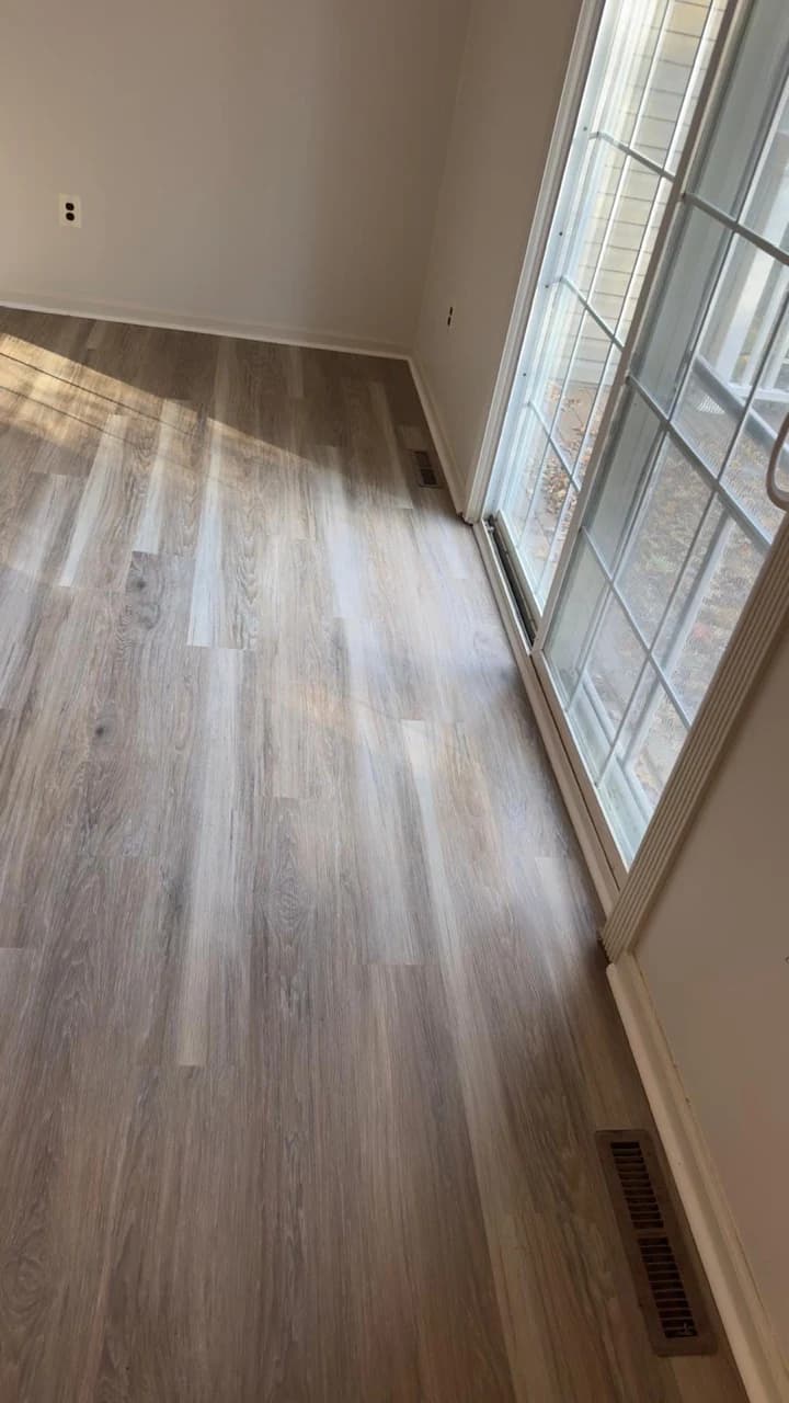 Gray and beige vinyl planks connecting residential rooms