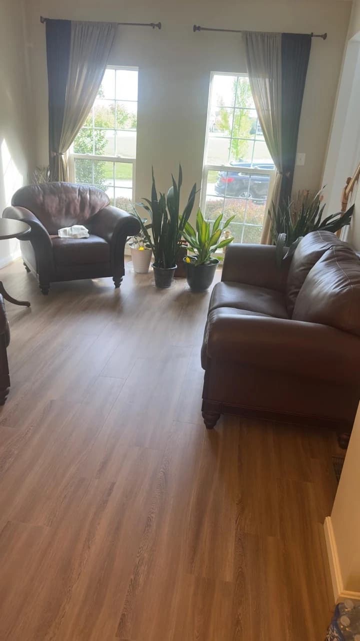 Light wood-look flooring in furnished living and dining spaces