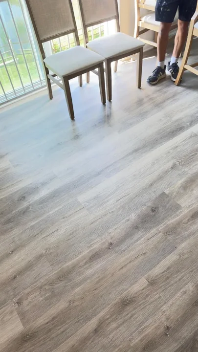 Gray-brown plank flooring beside a sliding glass door