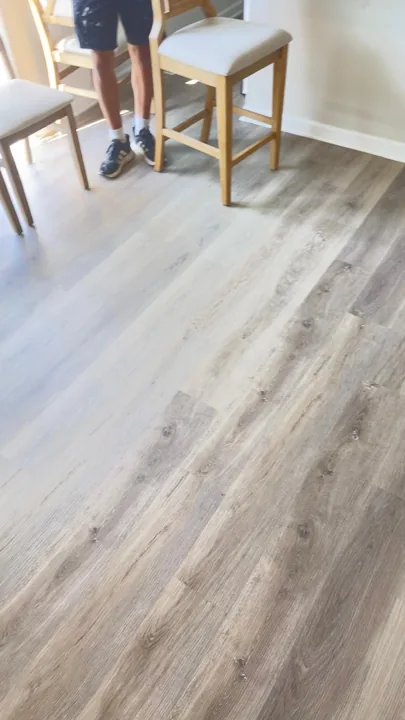 Gray-brown plank flooring beside a sliding glass door