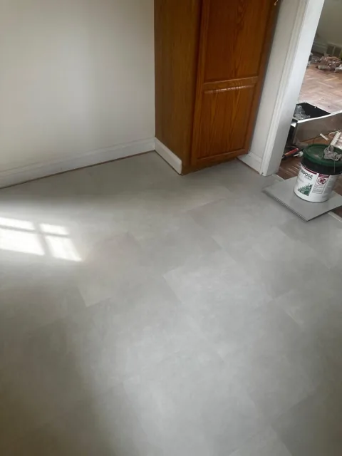 Light rectangular flooring beside wood cabinetry