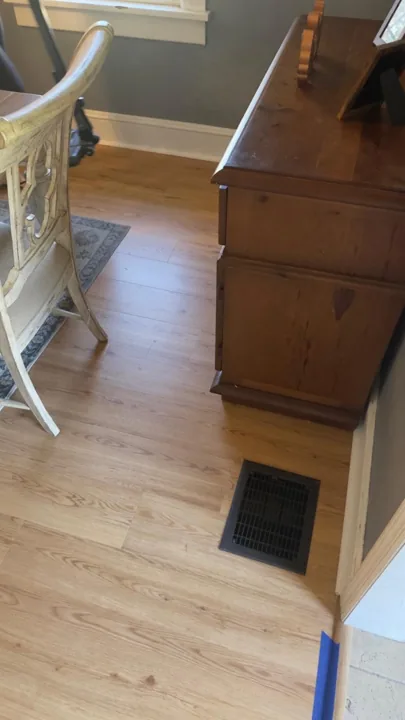 Warm wood-look flooring around dining furniture