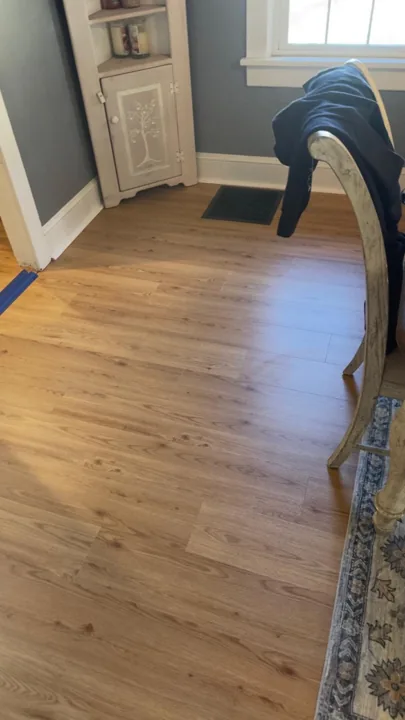 Warm wood-look flooring around dining furniture