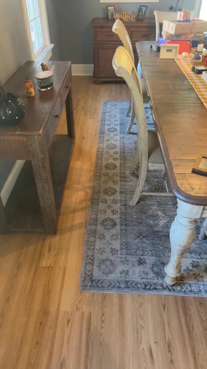 Warm wood-look flooring around dining furniture