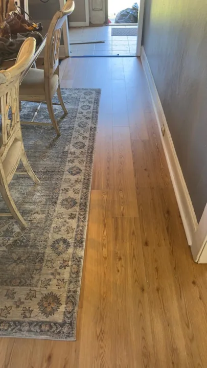 Warm wood-look flooring around dining furniture