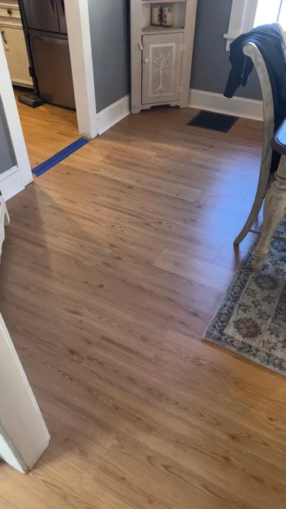 Warm wood-look flooring around dining furniture