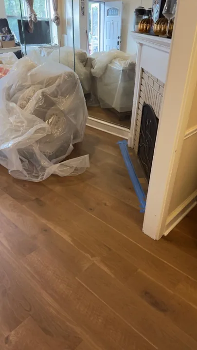 Wide warm-toned planks connecting residential rooms — work in progress