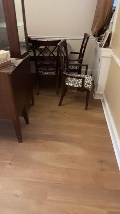 Wide warm-toned planks connecting residential rooms