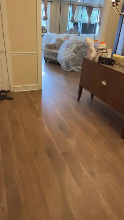 Wide warm-toned planks connecting residential rooms — work in progress