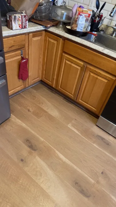 Wide warm-toned planks connecting residential rooms