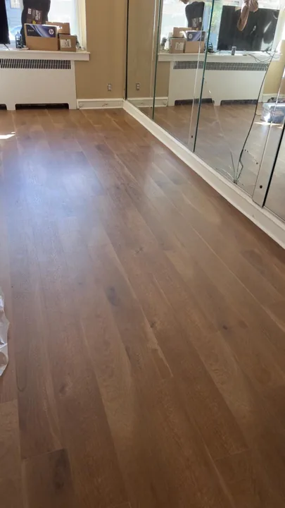 Wide warm-toned planks connecting residential rooms