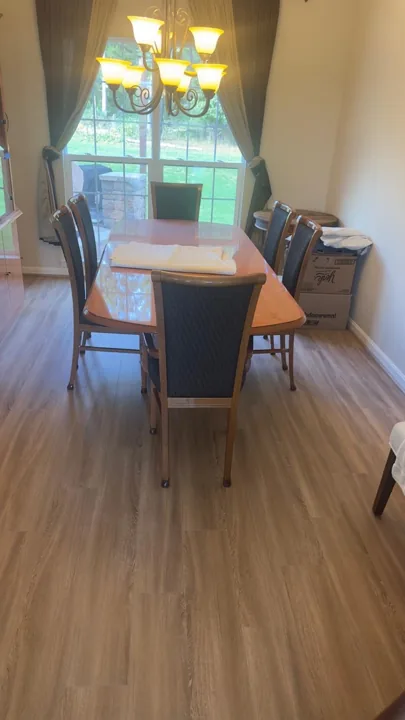 Light wood-look flooring in furnished living and dining spaces