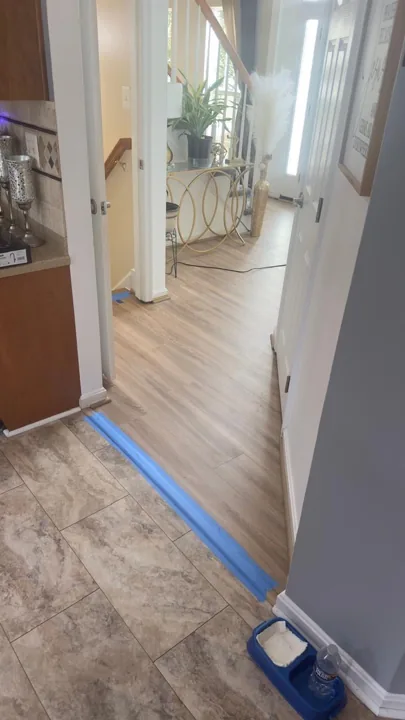 Light wood-look flooring in furnished living and dining spaces