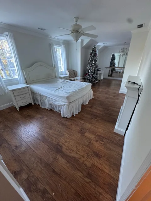 Dark textured plank flooring in a bright bedroom
