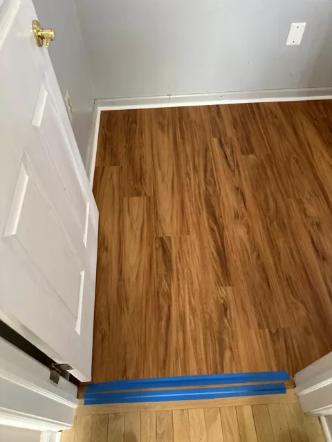 Amber-toned flooring in a residential utility room