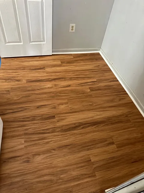 Amber-toned flooring in a residential utility room