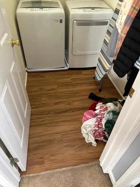 Amber-toned flooring in a residential utility room