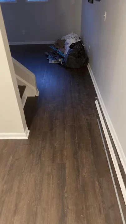 Dark brown plank flooring and installation details — work in progress