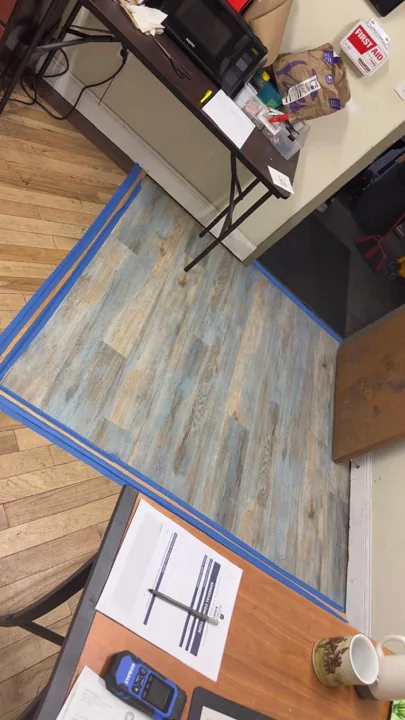 Blue-gray wood-look flooring with taped transition edges