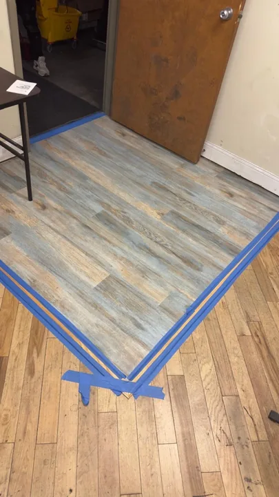 Blue-gray wood-look flooring with taped transition edges