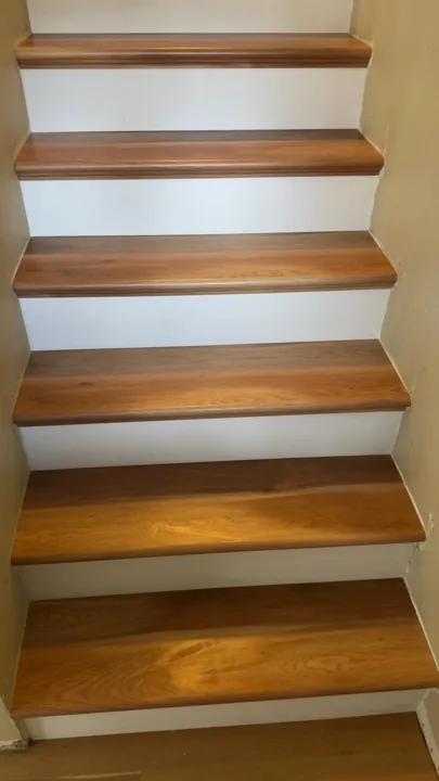 Warm wood-toned stair treads with white risers