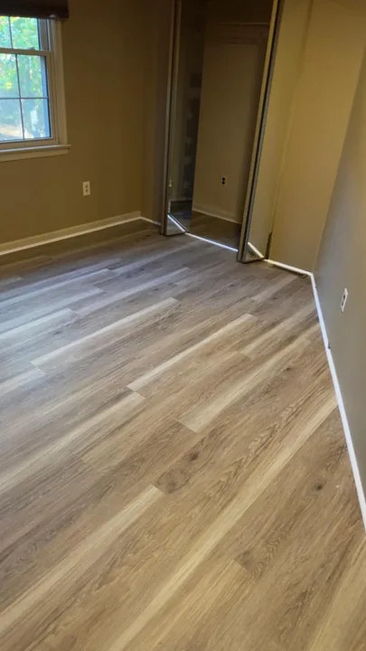 Gray and beige vinyl planks connecting residential rooms