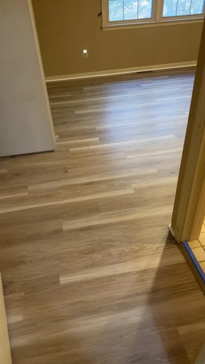 Gray and beige vinyl planks connecting residential rooms