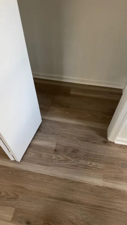 Gray and beige vinyl planks connecting residential rooms