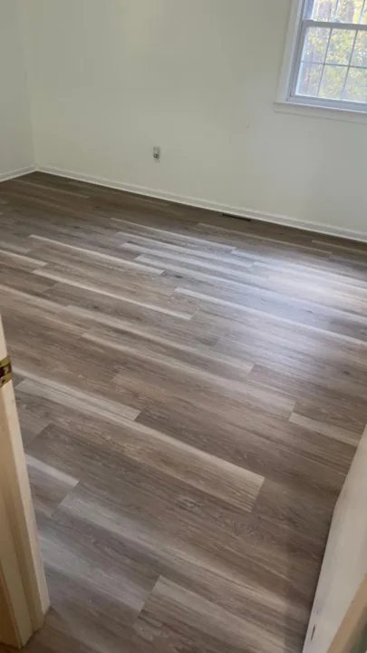 Gray and beige vinyl planks connecting residential rooms