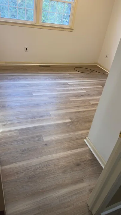 Gray and beige vinyl planks connecting residential rooms