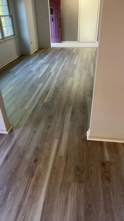 Gray and beige vinyl planks connecting residential rooms
