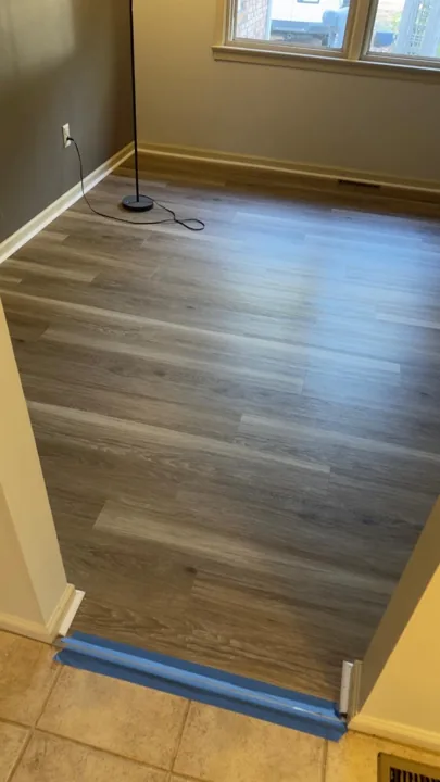 Gray and beige vinyl planks connecting residential rooms