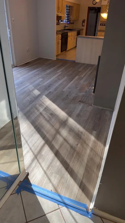 Gray and beige vinyl planks connecting residential rooms