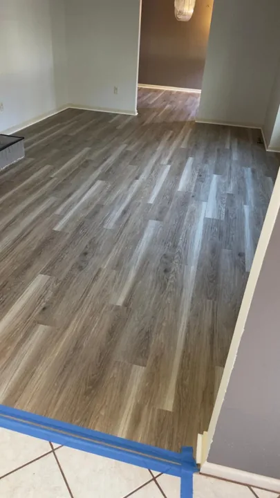 Gray and beige vinyl planks connecting residential rooms