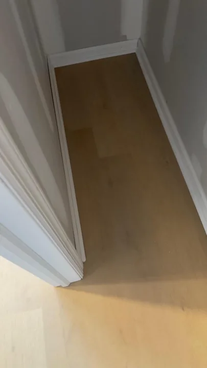 Pale wide-plank vinyl flooring during an interior renovation — work in progress