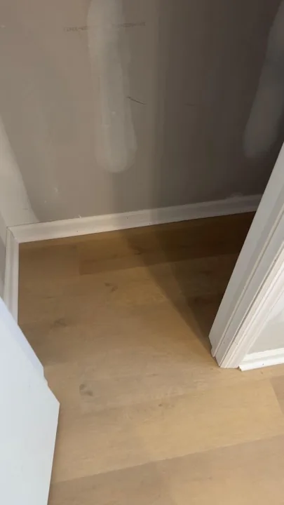 Pale wide-plank vinyl flooring during an interior renovation — work in progress