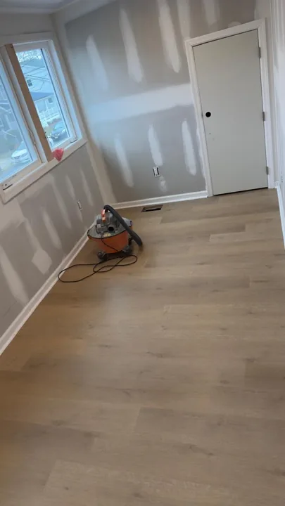 Pale wide-plank vinyl flooring during an interior renovation — work in progress