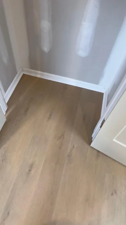 Pale wide-plank vinyl flooring during an interior renovation — work in progress