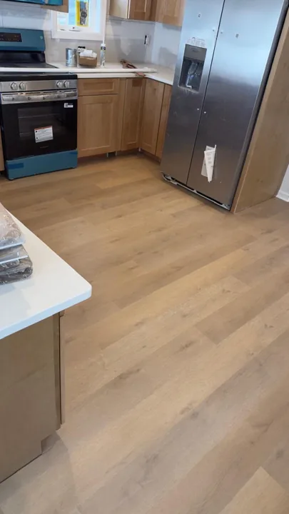 Pale wide-plank vinyl flooring during an interior renovation