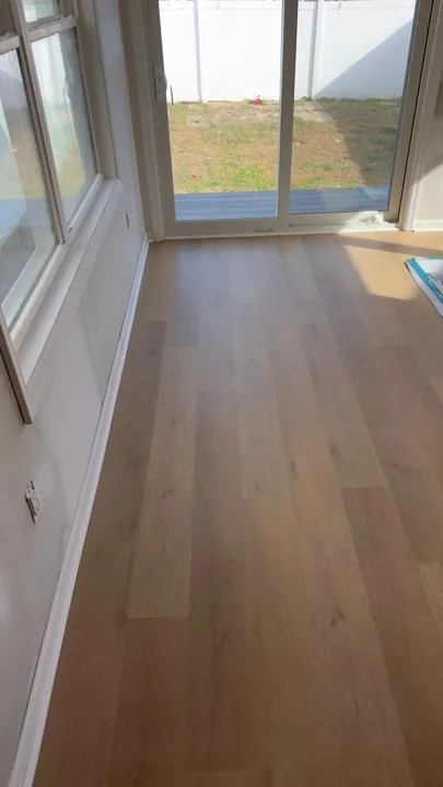 Pale wide-plank vinyl flooring during an interior renovation