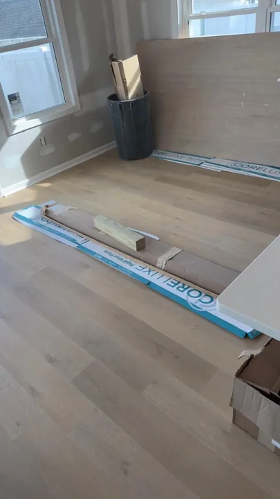 Pale wide-plank vinyl flooring during an interior renovation — work in progress
