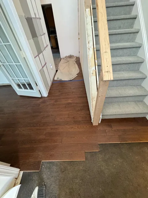 Brown hardwood flooring with pronounced natural grain — work in progress