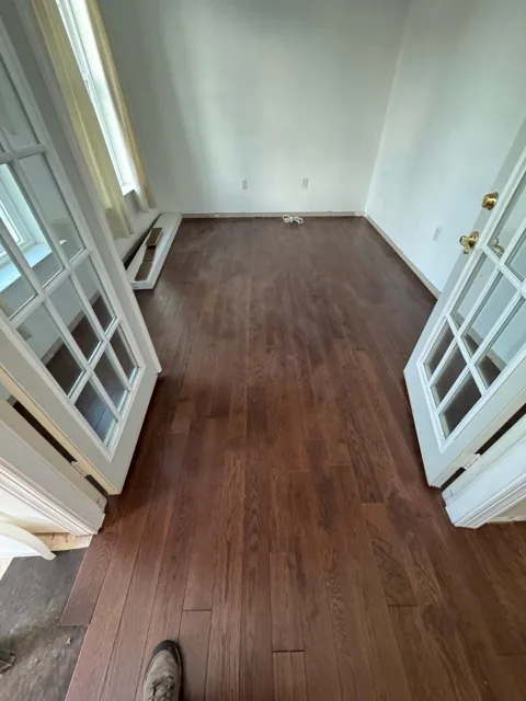 Brown hardwood flooring with pronounced natural grain — work in progress