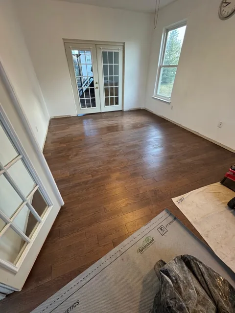 Brown hardwood flooring with pronounced natural grain — work in progress