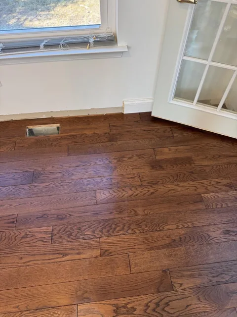 Brown hardwood flooring with pronounced natural grain — work in progress