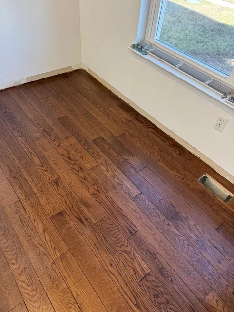 Brown hardwood flooring with pronounced natural grain — work in progress