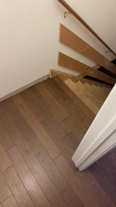 Brown hardwood flooring with pronounced natural grain — work in progress