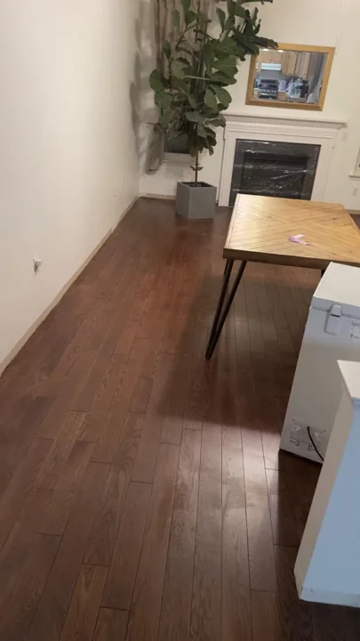 Brown hardwood flooring with pronounced natural grain — work in progress