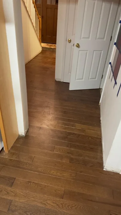 Brown hardwood flooring with pronounced natural grain — work in progress